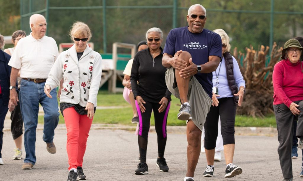 Four seniors doing leg exercises